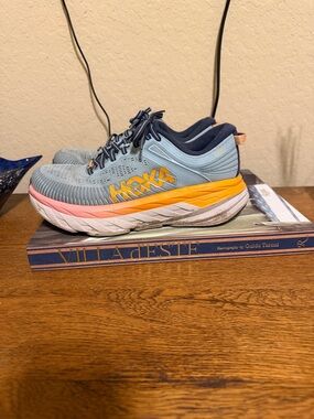 Hoka Light Blue Running Shoe with Yellow & Pink Accents